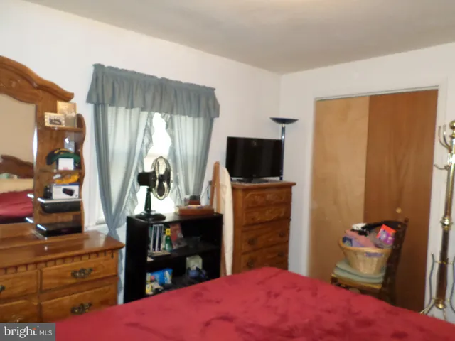 a bedroom with a bed and a flat tv screen