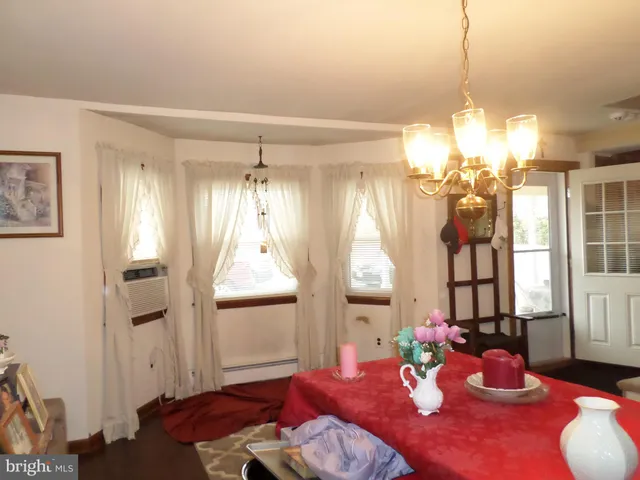 a backyard of a house with large trees and brick walls