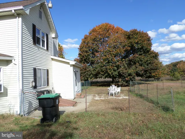 a view of a backyard with large trees