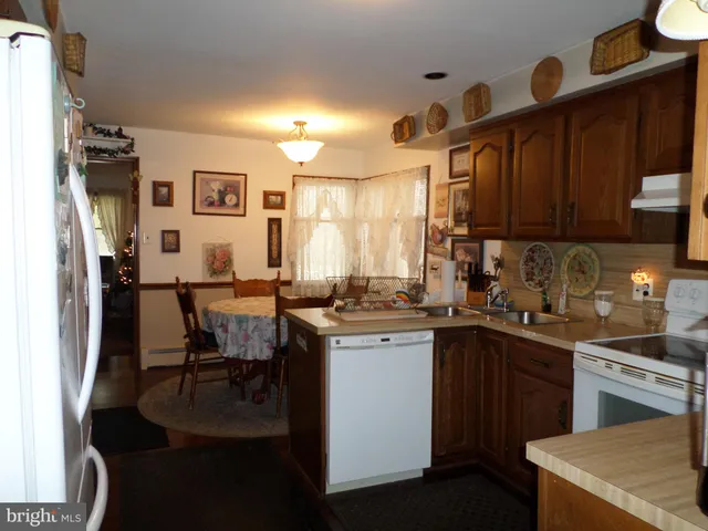 a kitchen with appliances cabinets and furniture