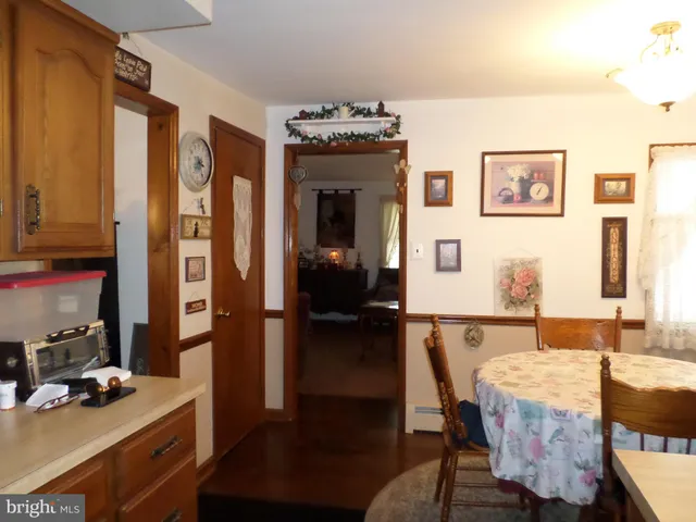a dining room with furniture and wooden floor