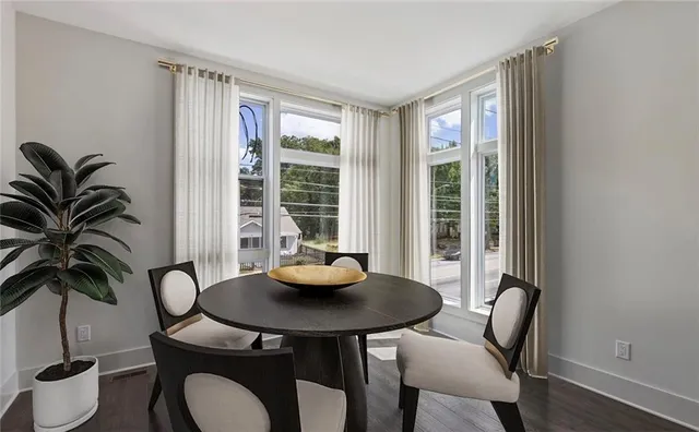 a view of a dining room with furniture window and wooden floor