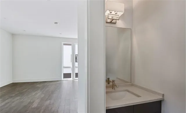 a view of a room with wooden floor and a window