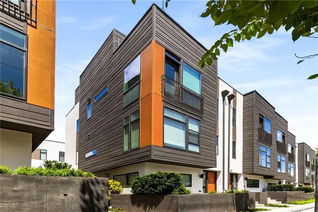 a yellow building with trees in front of it