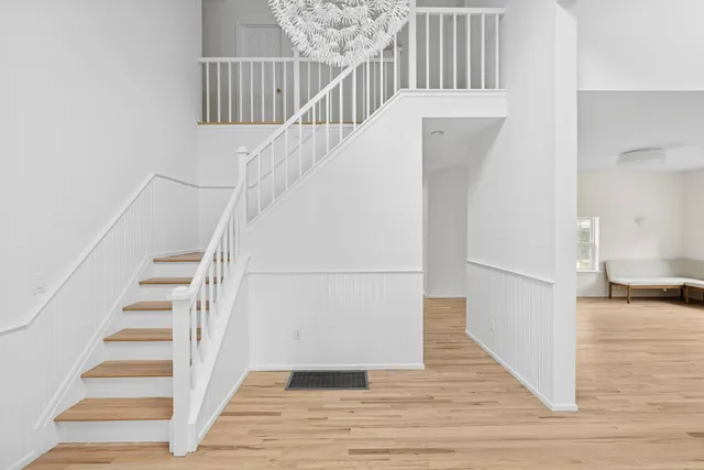 a view of entryway and hall with wooden floor