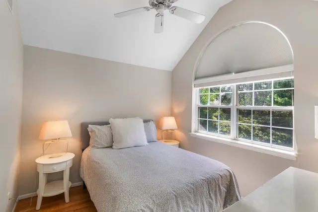 a bedroom with a large bed and a window