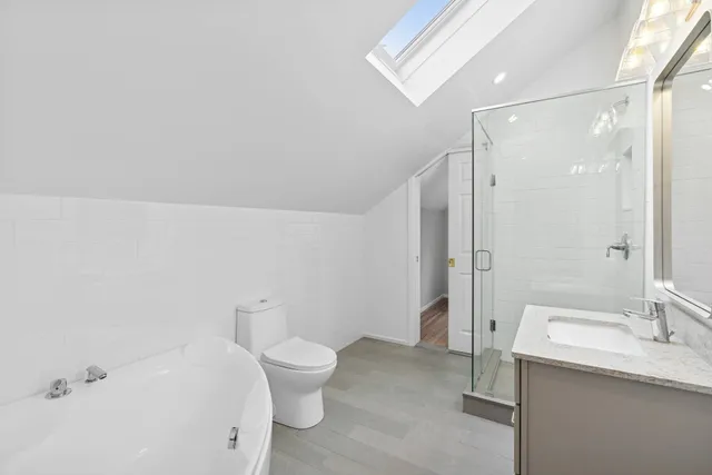a bathroom with a sink and mirror with toilet