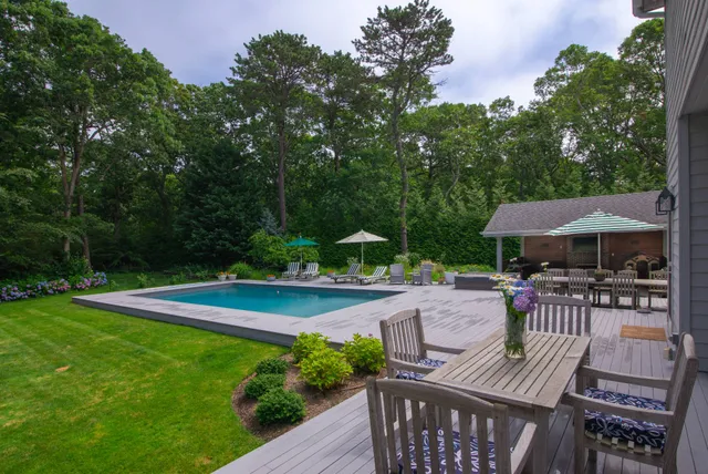 a view of swimming pool with outdoor seating yard and green space
