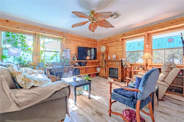 a living room with furniture a large window and a table