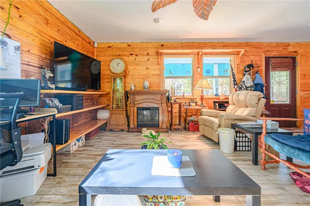 a living room with furniture a fireplace and a large window