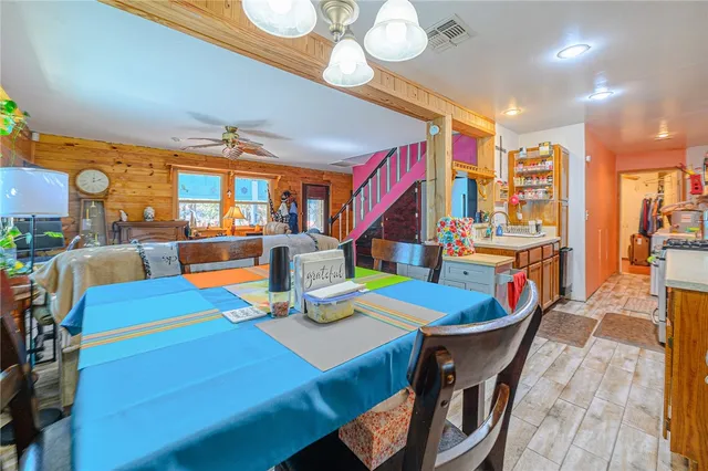 a view of a kitchen with furniture and wooden floor