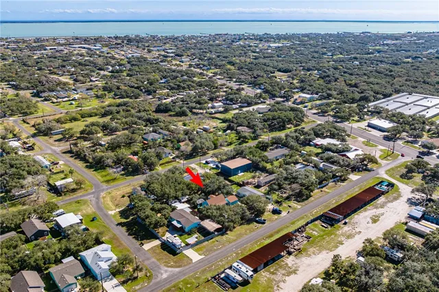an aerial view of a residential houses with yard