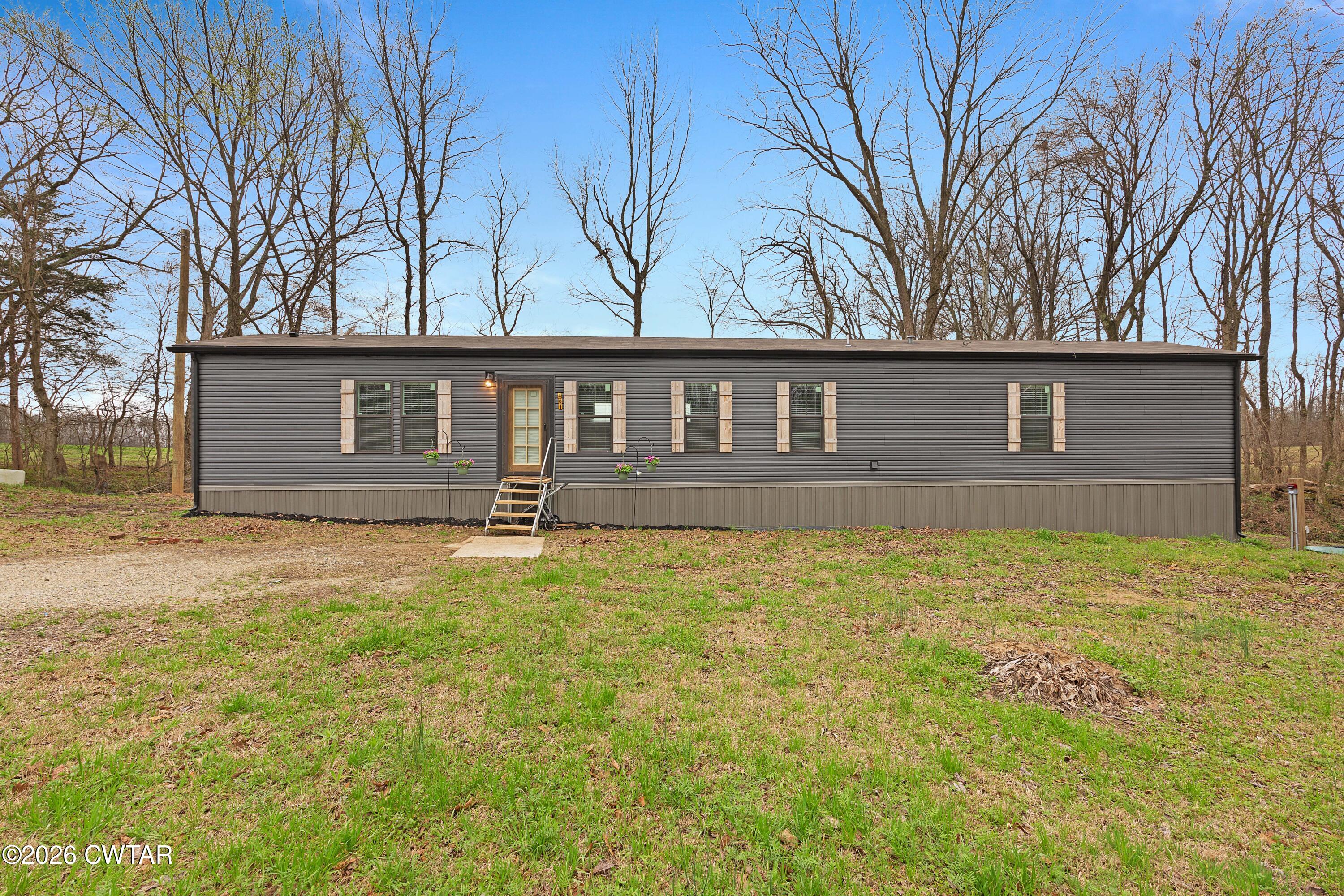 461 Humboldt Gibson Wells Road Humboldt, TN 38343 - Photo 1 of 24 a front view of a house with yard and trees