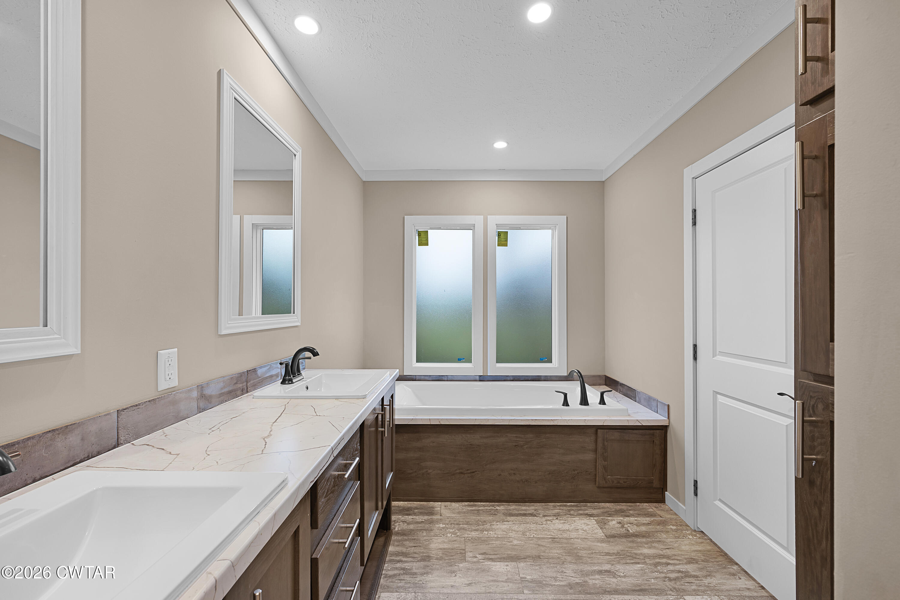 461 Humboldt Gibson Wells Road Humboldt, TN 38343 - Photo 20 of 24 a bathroom with double vanity sinks double vanity tub and a mirror