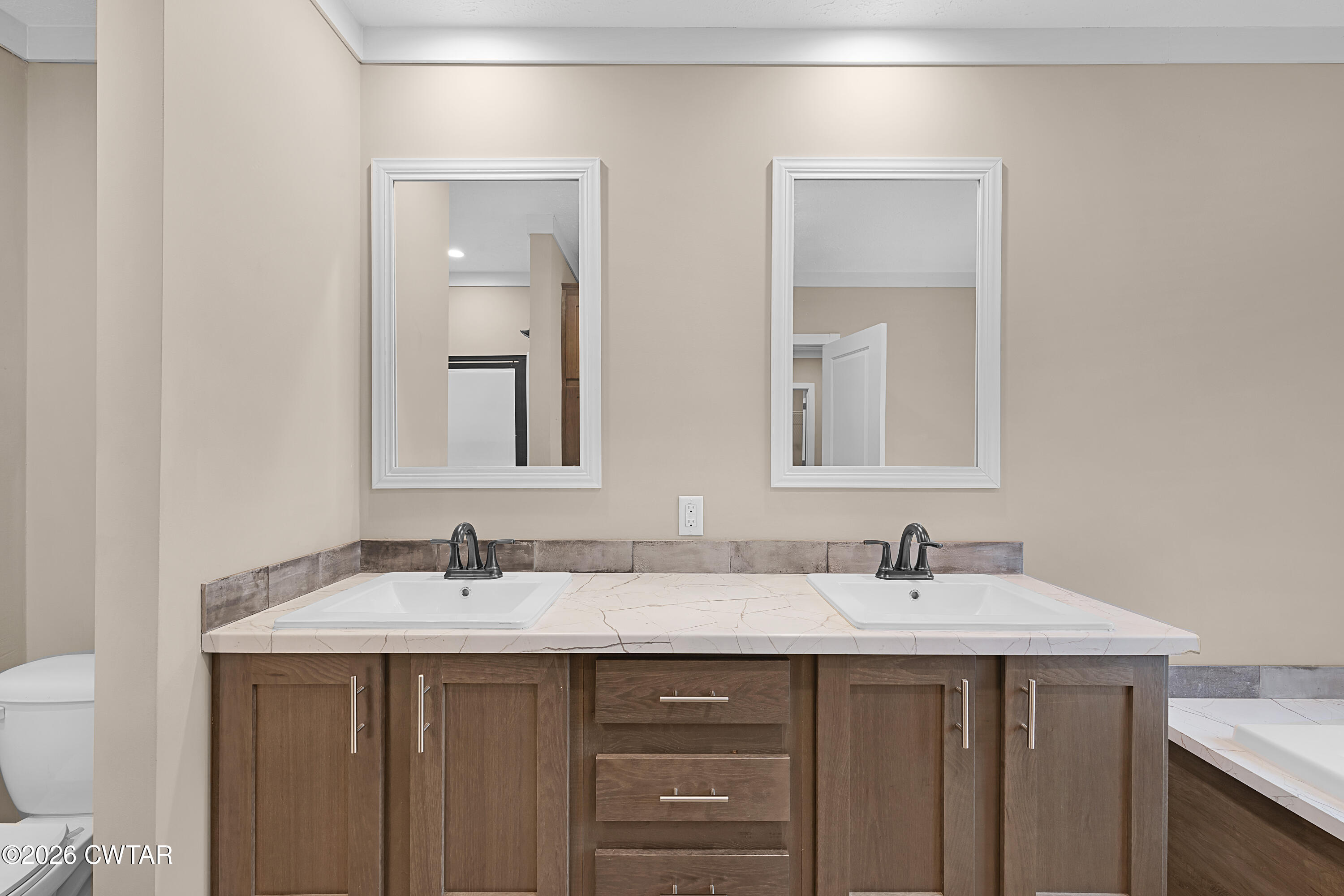 461 Humboldt Gibson Wells Road Humboldt, TN 38343 - Photo 21 of 24 a bathroom with 2 sink and a mirror