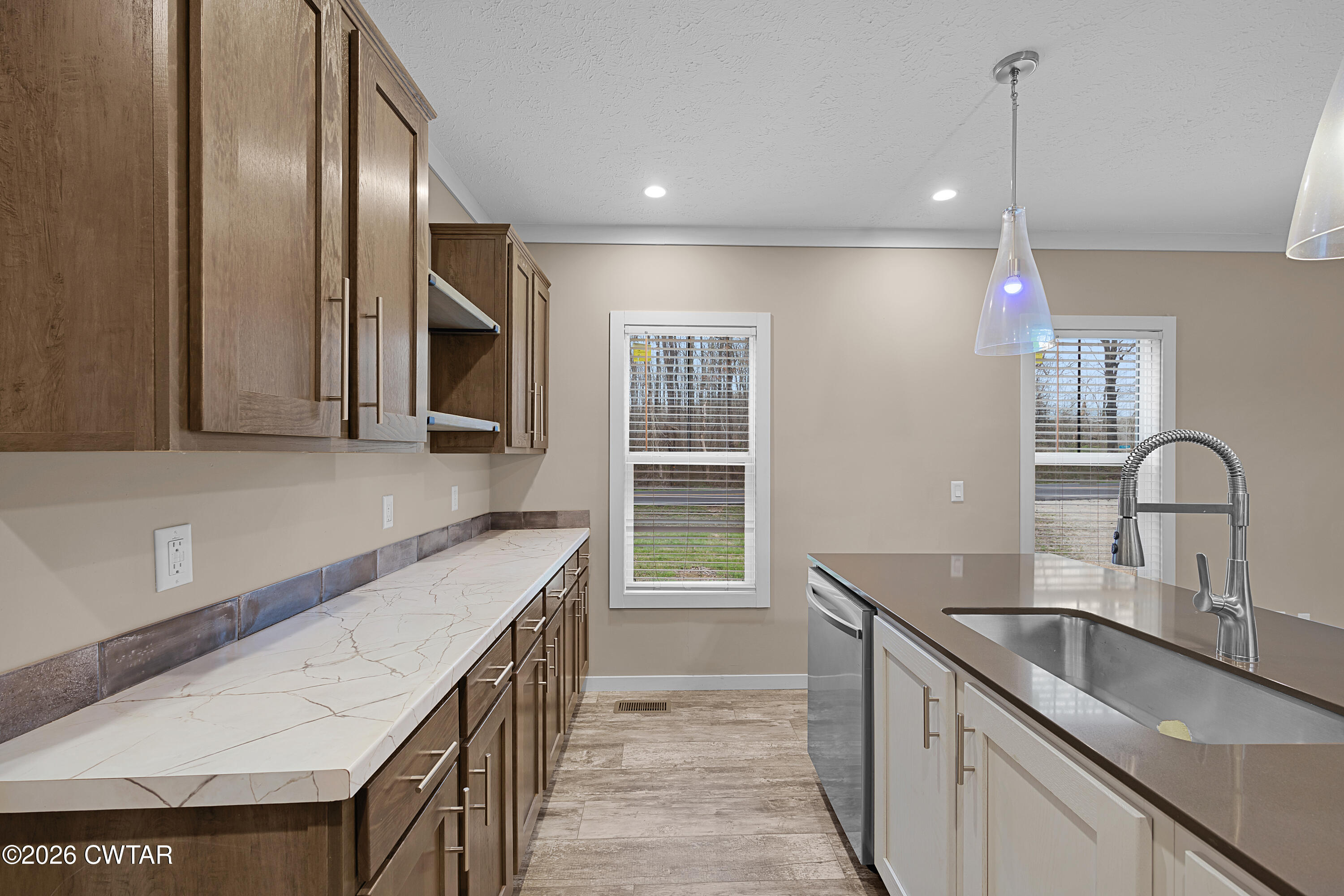 461 Humboldt Gibson Wells Road Humboldt, TN 38343 - Photo 6 of 24 a kitchen with a sink stove and cabinets