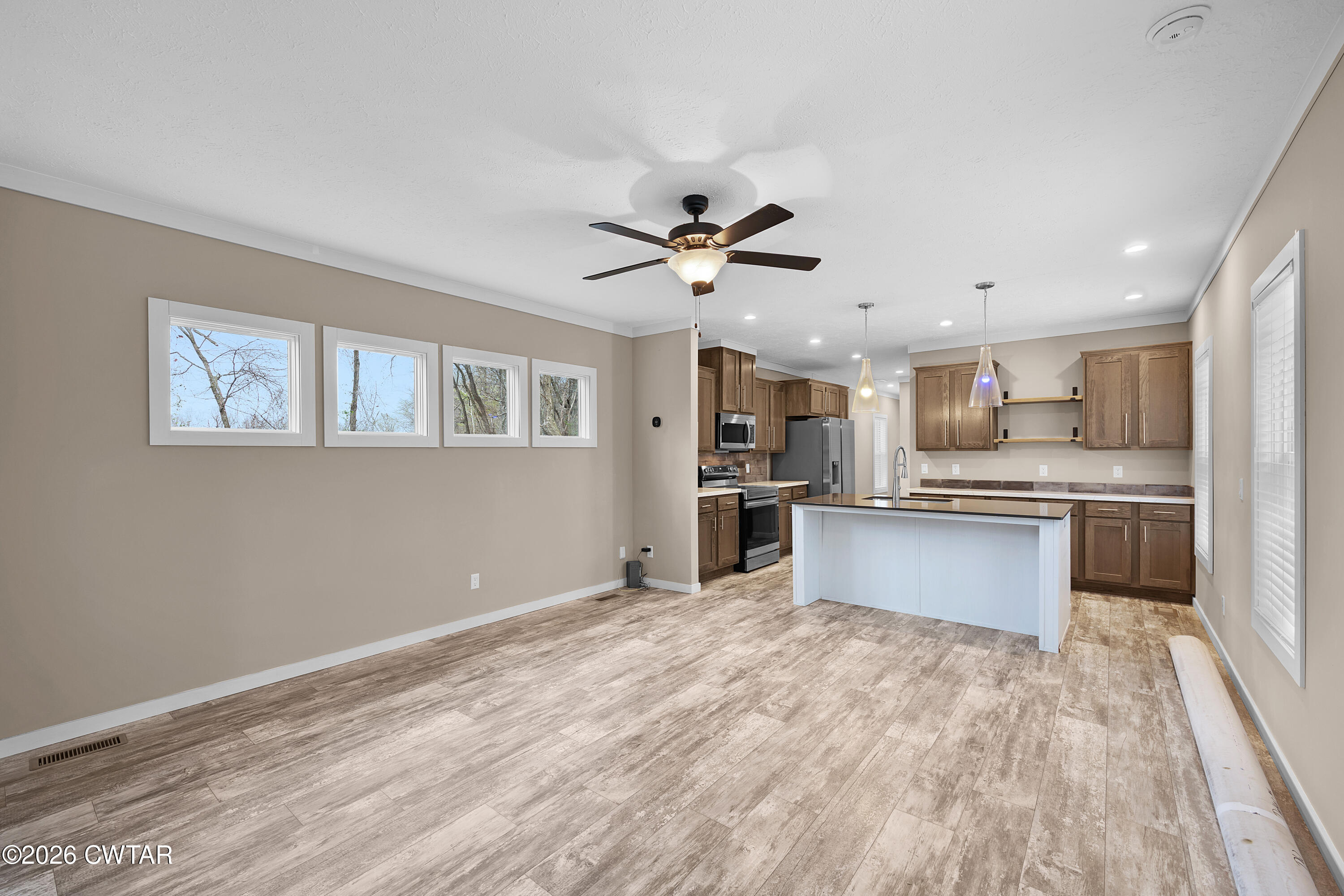 461 Humboldt Gibson Wells Road Humboldt, TN 38343 - Photo 8 of 24 a large kitchen with granite countertop a large counter top stainless steel appliances and cabinets