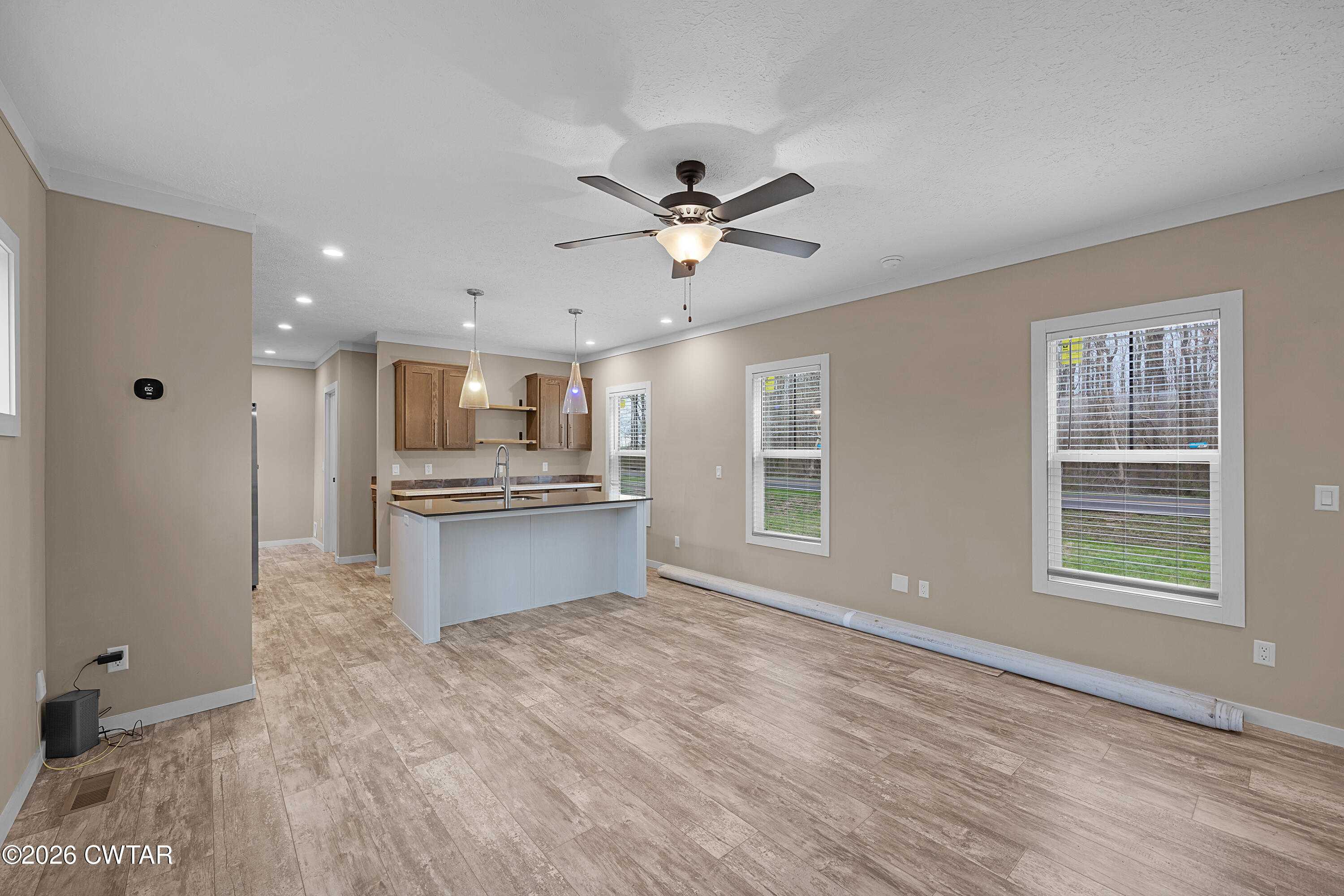 461 Humboldt Gibson Wells Road Humboldt, TN 38343 - Photo 9 of 24 a large kitchen with kitchen island white cabinets and stainless steel appliances