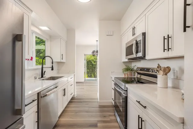 a kitchen with a sink stove and refrigerator