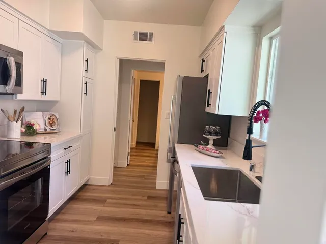 a kitchen with a sink and a refrigerator