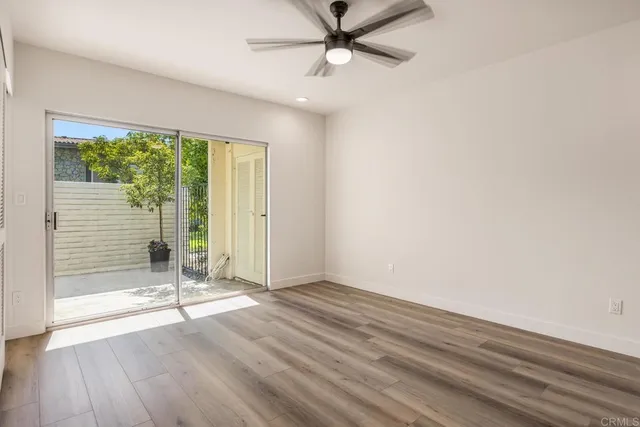 a bed sitting in a bedroom next to a window with a chandelier