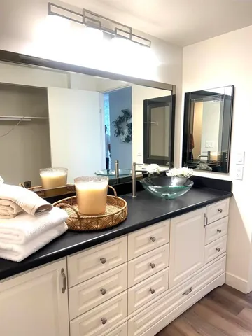 a hallway with sink and mirror