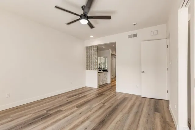 a view of a bedroom with wooden floor