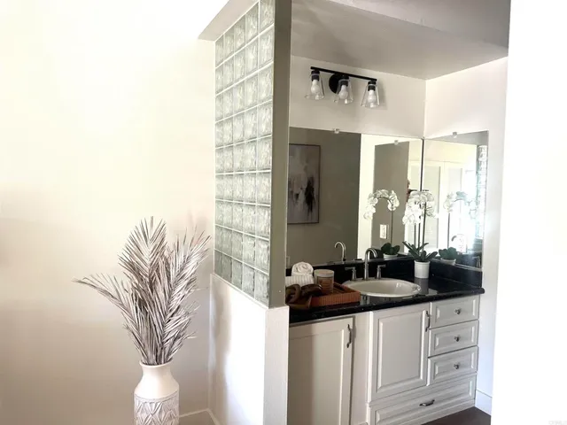 a bathroom with a double vanity sink and mirror