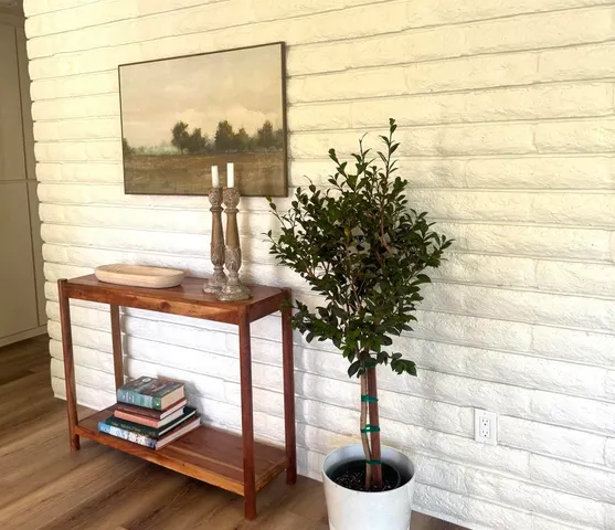 a living room with furniture or wooden floor and a fireplace