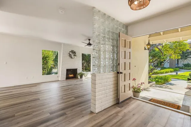 a living room with furniture fireplace and wooden floor
