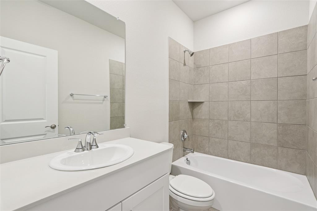 2709 Grand Cyn Street Anna, TX 75409 - Photo 19 of 40 a bathroom with a sink a toilet and bathtub