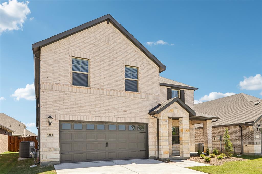 2709 Grand Cyn Street Anna, TX 75409 - Photo 2 of 40 a front view of a house with a yard