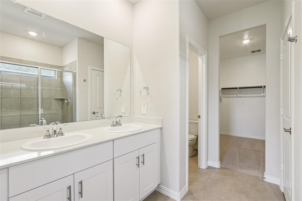 2709 Grand Cyn Street Anna, TX 75409 - Photo 23 of 40 a bathroom with a double vanity sink mirror and double