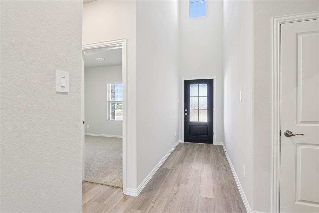2709 Grand Cyn Street Anna, TX 75409 - Photo 3 of 40 a view of a hallway with wooden floor and closet