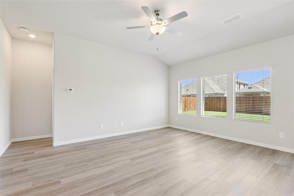 2709 Grand Cyn Street Anna, TX 75409 - Photo 4 of 40 a view of an empty room with a window and wooden floor