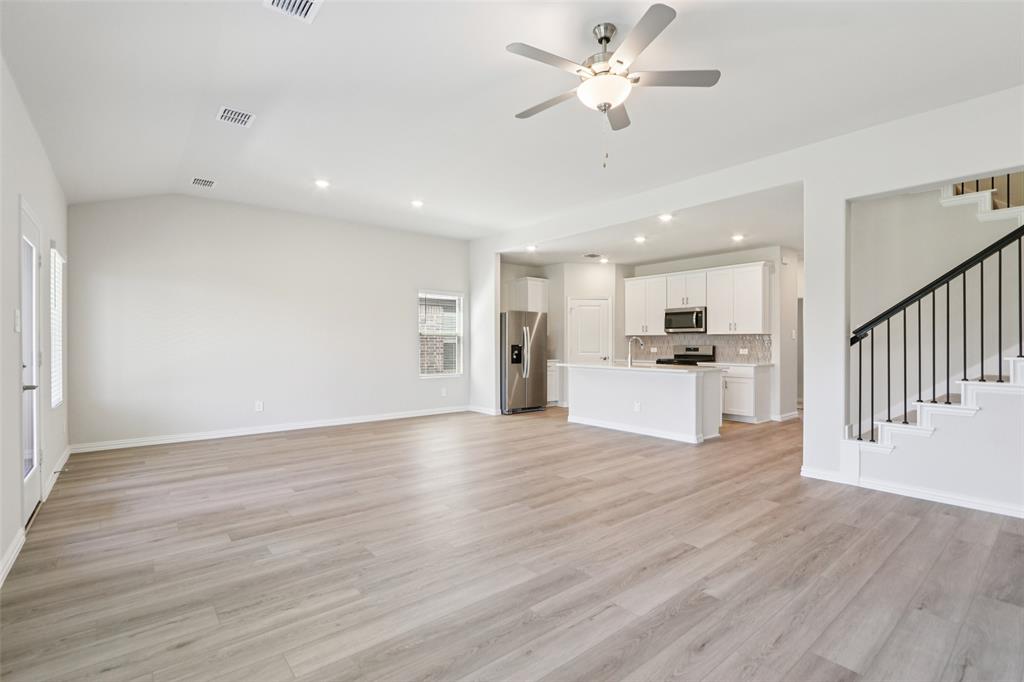 2709 Grand Cyn Street Anna, TX 75409 - Photo 7 of 40 a view of a kitchen with wooden floor and a kitchen view
