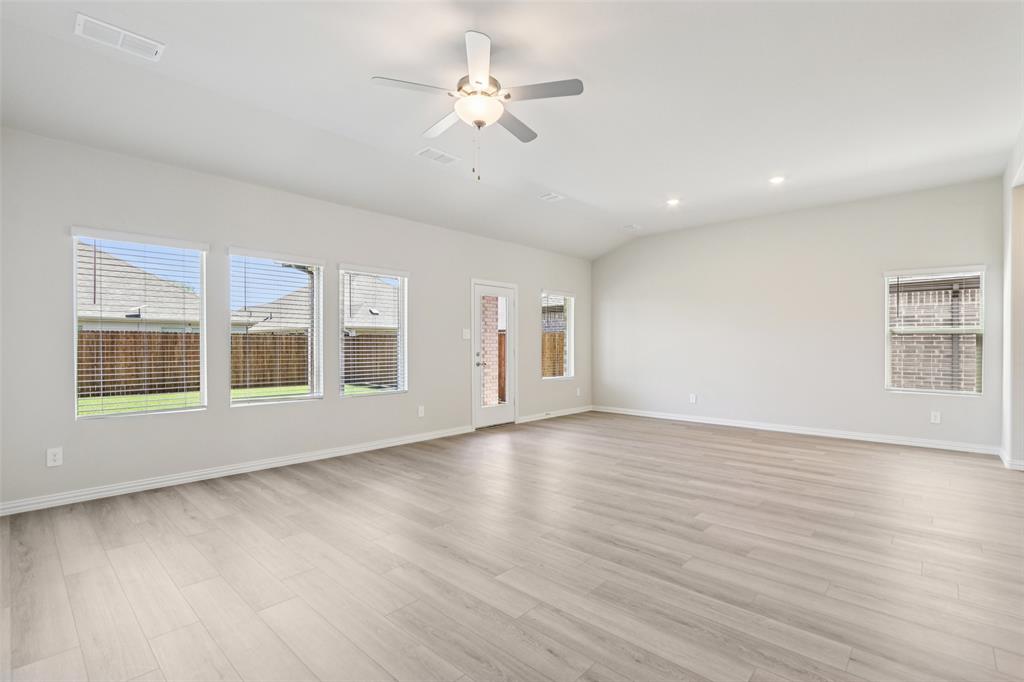 2709 Grand Cyn Street Anna, TX 75409 - Photo 8 of 40 a view of an empty room with a window and wooden floor