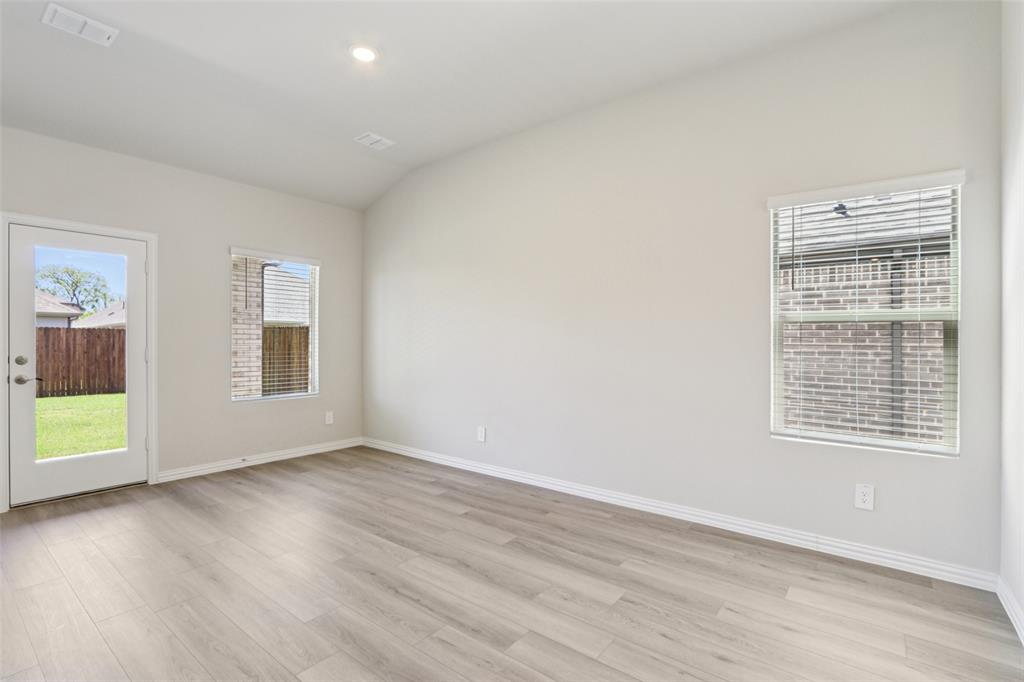 2709 Grand Cyn Street Anna, TX 75409 - Photo 9 of 40 an empty room with wooden floor and windows