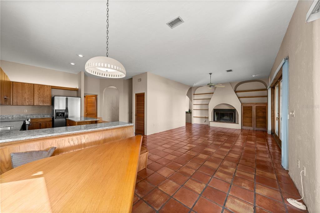 12621 Southeast Sunset Harbor Road Weirsdale, FL 32195 - Photo 14 of 54 a view of a kitchen with a sink and a refrigerator