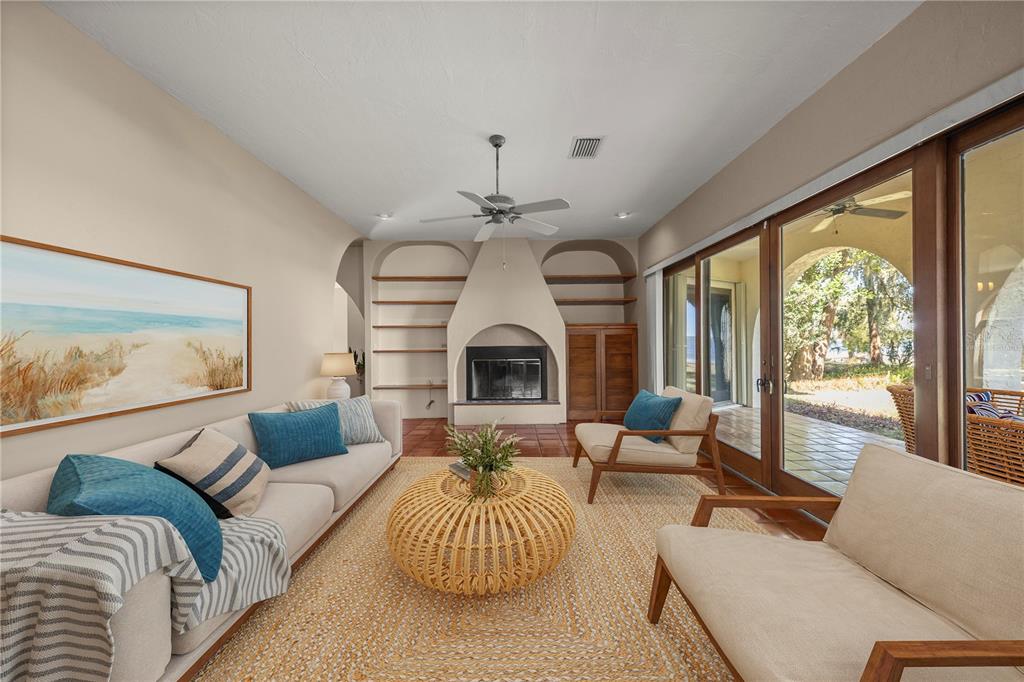 12621 Southeast Sunset Harbor Road Weirsdale, FL 32195 - Photo 15 of 54 a living room with furniture chandelier and a large window