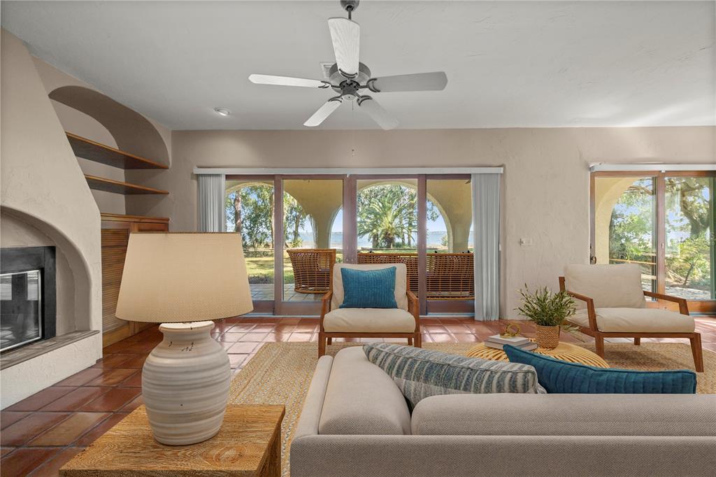 12621 Southeast Sunset Harbor Road Weirsdale, FL 32195 - Photo 16 of 54 a living room with furniture and a large window