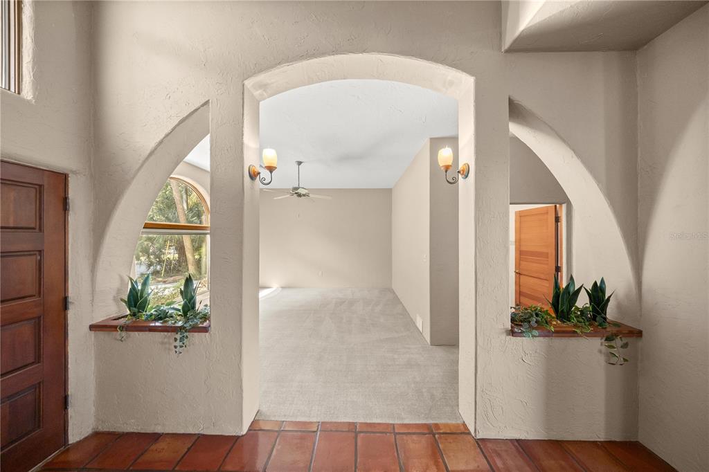 12621 Southeast Sunset Harbor Road Weirsdale, FL 32195 - Photo 18 of 54 view of a hallway view with wooden floor and a livingroom