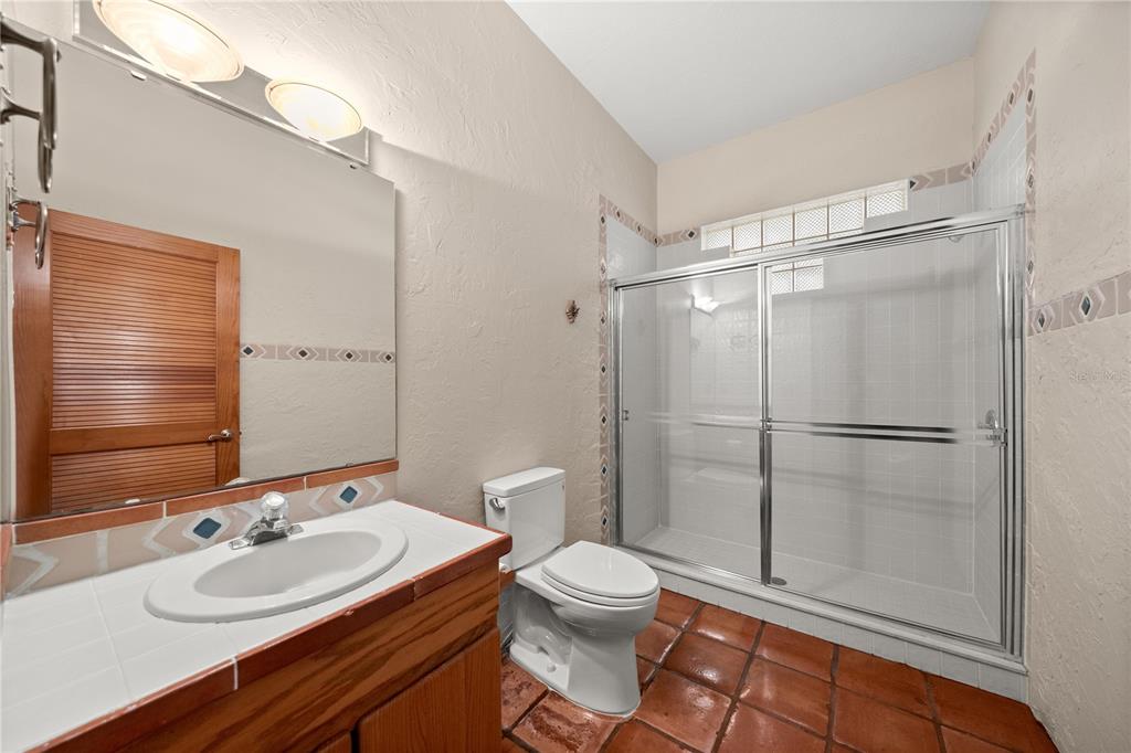 12621 Southeast Sunset Harbor Road Weirsdale, FL 32195 - Photo 21 of 54 a bathroom with a sink toilet and shower