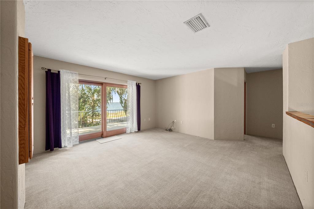 12621 Southeast Sunset Harbor Road Weirsdale, FL 32195 - Photo 24 of 54 a view of an empty room with a window