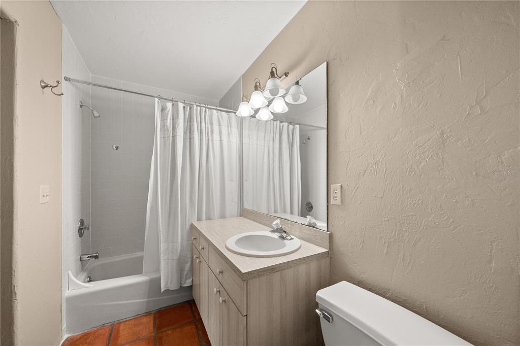 12621 Southeast Sunset Harbor Road Weirsdale, FL 32195 - Photo 34 of 54 a bathroom with a sink a toilet and shower