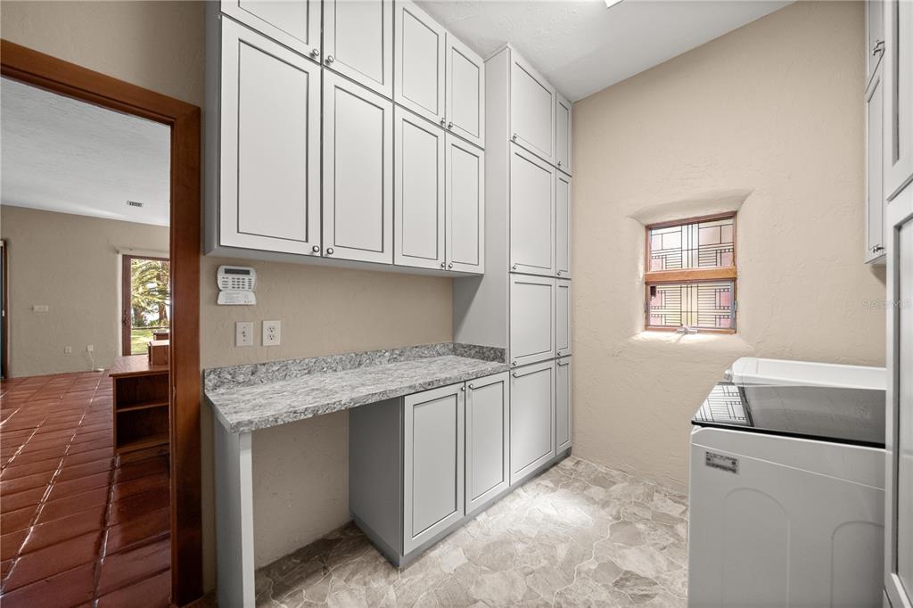 12621 Southeast Sunset Harbor Road Weirsdale, FL 32195 - Photo 39 of 54 a kitchen with stainless steel appliances granite countertop a sink stove and cabinets