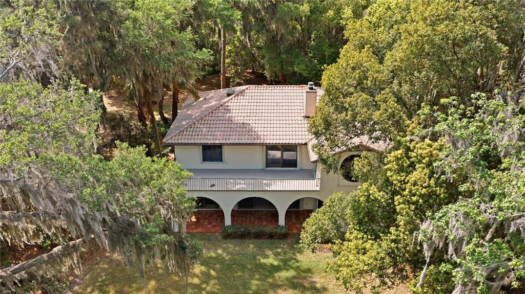 12621 Southeast Sunset Harbor Road Weirsdale, FL 32195 - Photo 45 of 54 an aerial view of a house with a yard and balcony