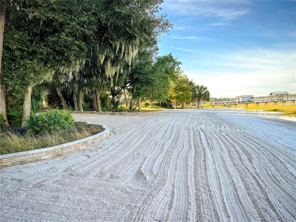 12621 Southeast Sunset Harbor Road Weirsdale, FL 32195 - Photo 50 of 54 a view of a swimming pool and an outdoor space