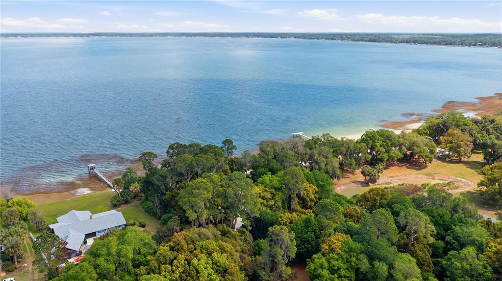 12621 Southeast Sunset Harbor Road Weirsdale, FL 32195 - Photo 53 of 54 an aerial view of a houses with a lake view