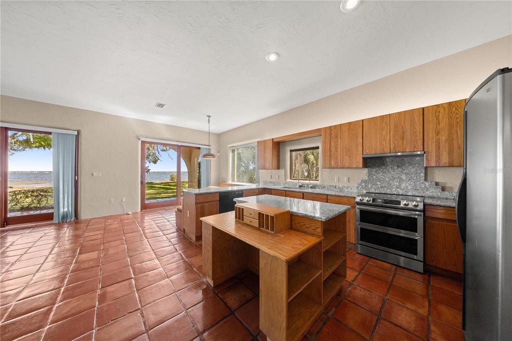 12621 Southeast Sunset Harbor Road Weirsdale, FL 32195 - Photo 10 of 54 a kitchen with a sink cabinets and appliances